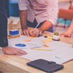 view of documents on a table with various colored sticky notes
