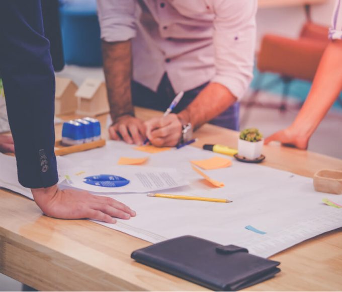 view of documents on a table with various colored sticky notes
