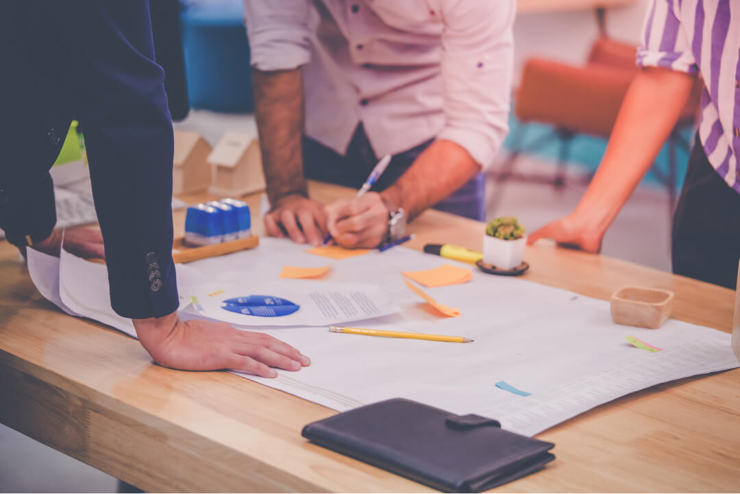 view of documents on a table with various colored sticky notes