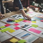 view of documents on a table with various colored sticky notes