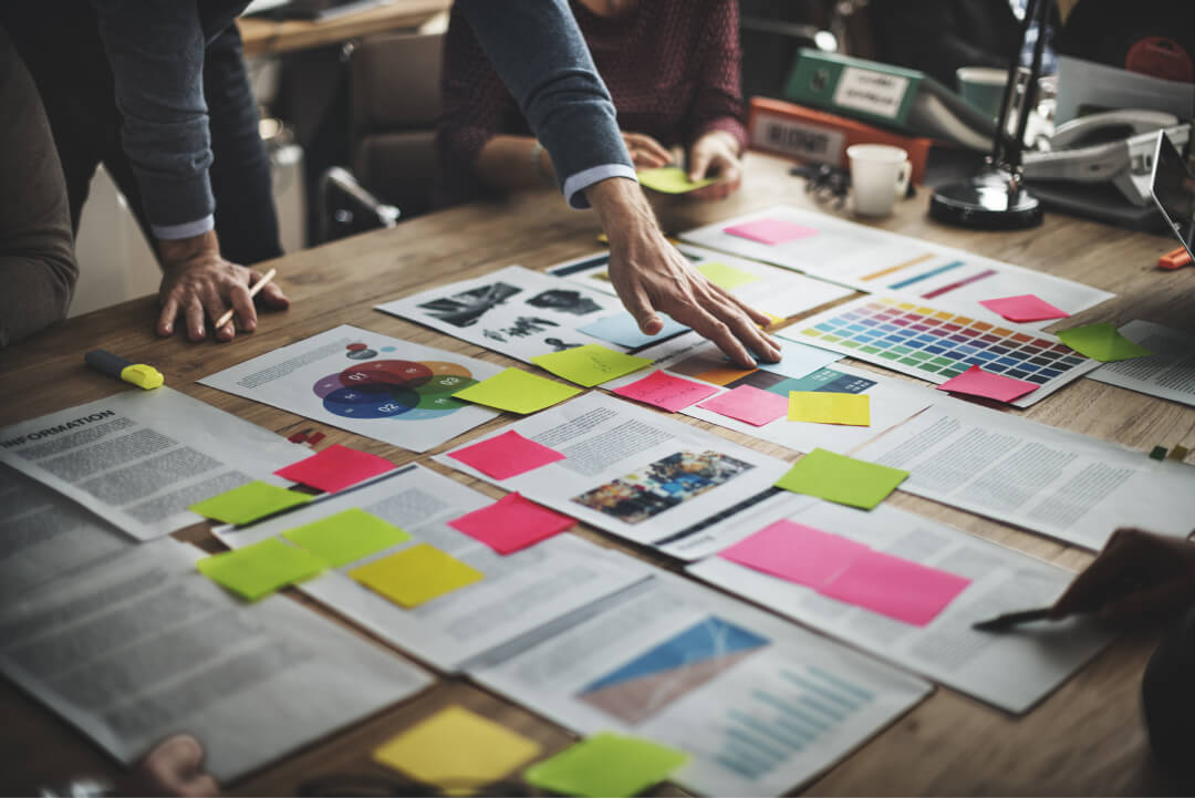 view of documents on a table with various colored sticky notes